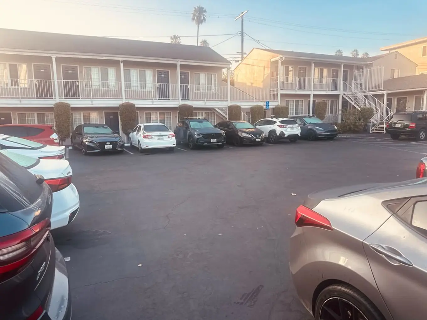 Two-story courtyard exterior and parking area at Friendship Motor Inn