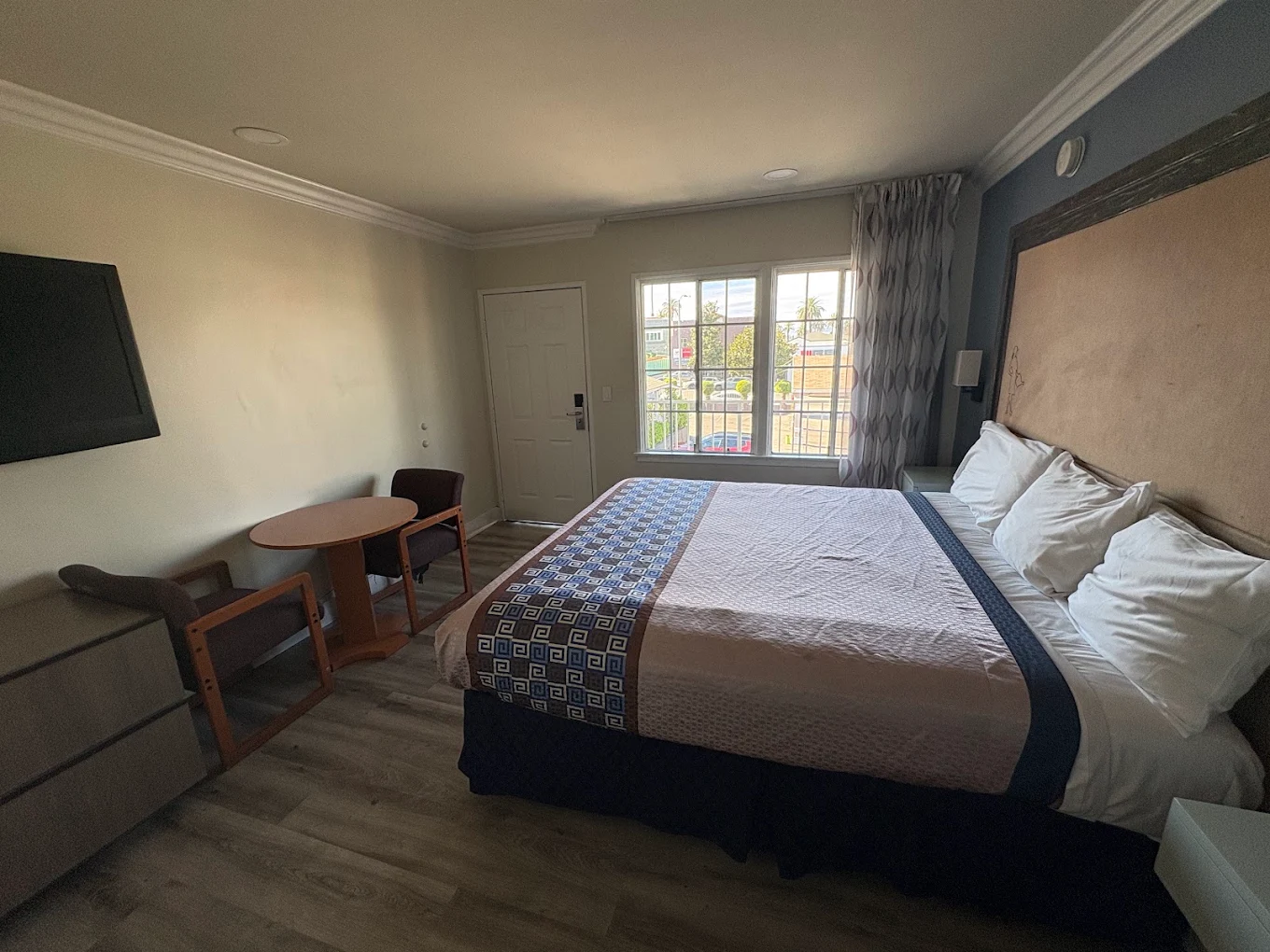 Clean guest room with comfortable bedding at Friendship Motor Inn